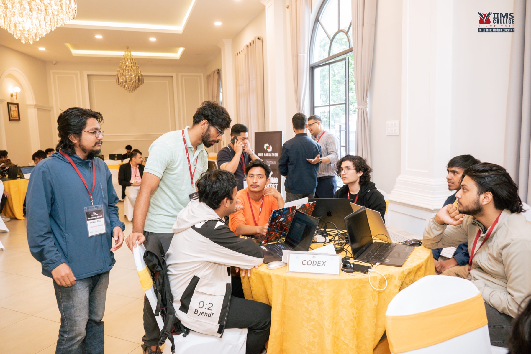 A mentor speaking with a student team during the codefest