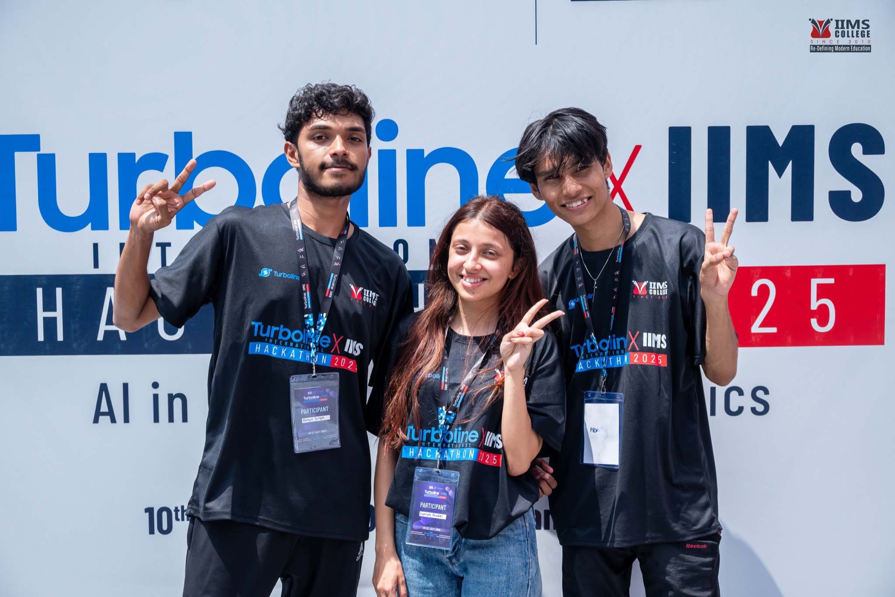 A participant team standing in front of the Turboline Hackathon backdrop
